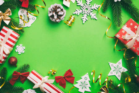 Christmas decorations and fir tree branch and gift boxon dark table. Top view frame with copy space.の写真素材