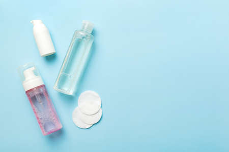 Micellar cleansing water and discs to remove cosmetics and cleanse the skin on colored background....