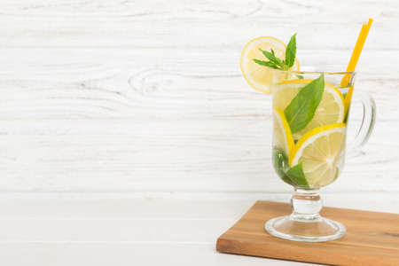 Mojito cocktail. Refreshing mojito cocktail with lime, lemon and mint in a tall glass with a stick.