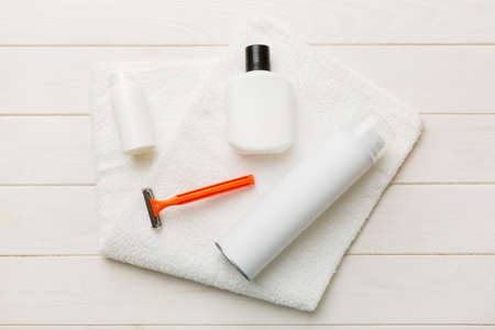 shaving man set. shaving machine, towel, lotion and shaving foam on colored background. Men bath...