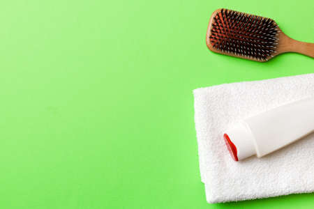 cosmetic for hair care, cream and towel on a colored background top view. flat lay.