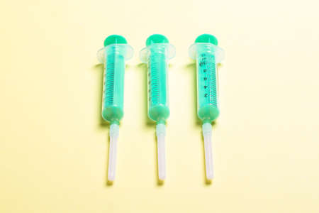 Top view of syringes in a row for medical injection on colorful background with copy space. Health and vaccination concept.の写真素材