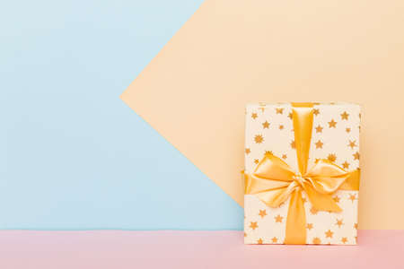 holiday paper present tied yellow ribbon bow top view with copy space. Flat lay holiday background....