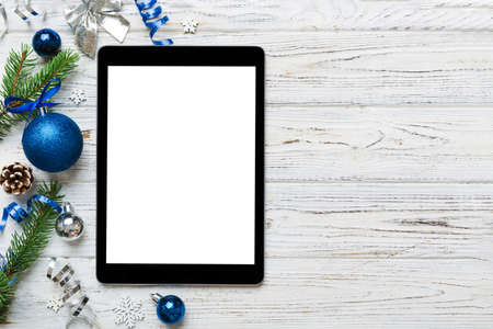 Digital tablet mock up with rustic Christmas decorations for app presentation top view with empty...
