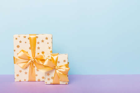 holiday paper present tied yellow ribbon bow top view with copy space. Flat lay holiday background....