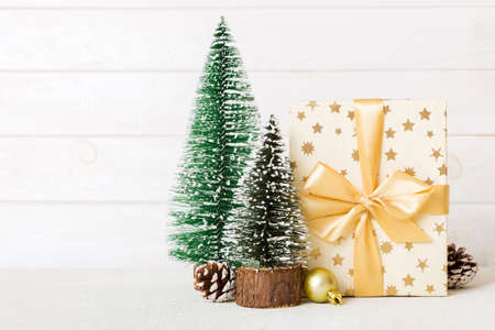 christmas composition. craft Gift box, small tree, branches and craft DIY decorations on white background. new year concept. Christmas home decoration Flat lay, top view, copy space.の写真素材