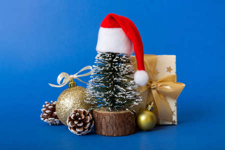 christmas composition. craft Gift box, small tree, branches and craft DIY decorations on white...