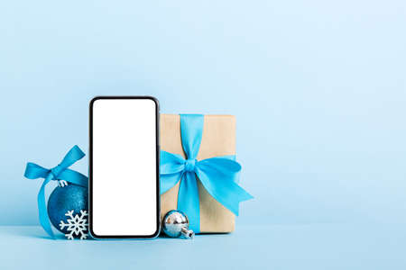 Digital phone mock up with rustic Christmas decorations for app presentation with empty space for...
