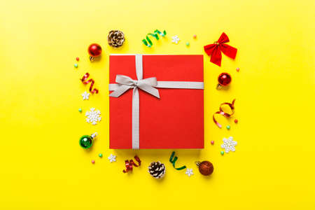 Top view Flat lay Christmas decorations and gift box on colored background with copy space....