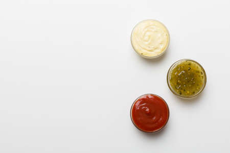 Different types of sauces in bowls on a colored Board . top view. various sauces copy space.の写真素材