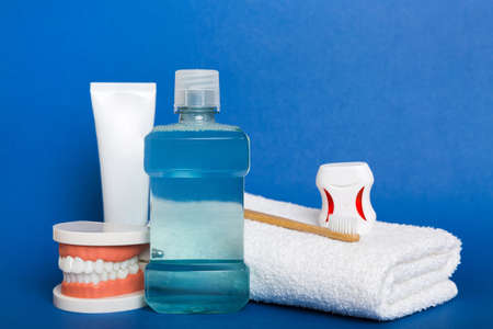 Mouthwash and other oral hygiene products on colored table top view with copy space. flat lay....