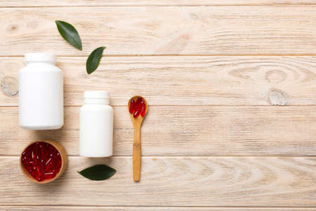 different drugs and health supplement pills with medicine bottle health care and medical top view. vitamin tablets. Bottle with colored pills on table background. multivitamins.の写真素材