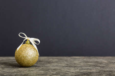 Christmas ball on colored background. decoration bauble with ribbon bow with copy space.の写真素材