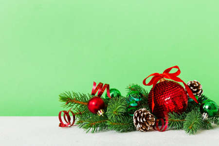 New Year Christmas tree toy, branches of a christmas tree, New Year decorations on a colored background.の写真素材