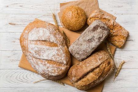 Assortment of freshly baked bread with napkin on rustic table top view. Healthy unleavened bread. French bread.の写真素材