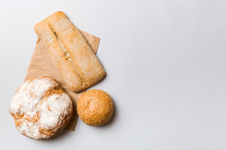 Assortment of freshly baked bread with napkin on rustic table top view. Healthy unleavened bread. French bread.の写真素材