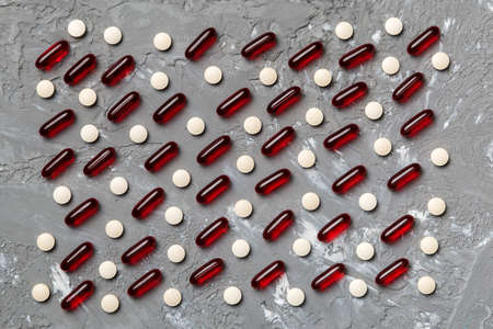 Many different pills and space for text on colorful background, top view. Different pills on color background, flat lay.の写真素材