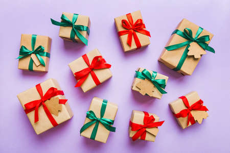 Colored craft gift boxes with colorful ribbons on colored background. Collection of Christmas present boxes.の写真素材