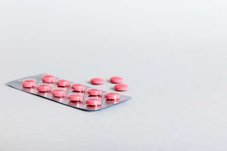 Blister package with Vitamin on color background. Medicine pills on a light background. Medicines...