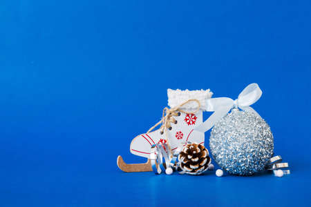 Christmas ball with skates on colored background. decoration bauble with ribbon bow with copy space.の写真素材