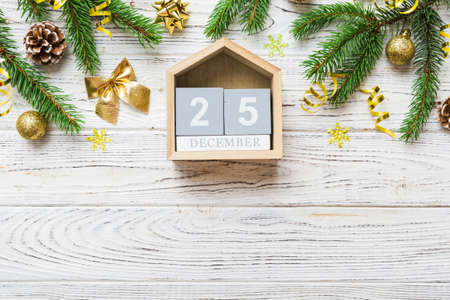 Christmas calendar 25 december. Christmas gift, fir branches, pine cones. Flat lay, top view. New Year decorations on a colored background.の写真素材