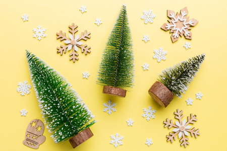 Flat lay composition with christmas trees on color background. Top view with copy space.