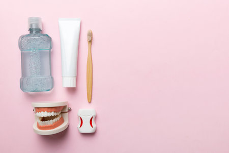 Mouthwash and other oral hygiene products on colored table top view with copy space. flat lay....