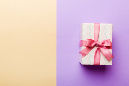 holiday paper present tied pink ribbon bow top view with copy space. Flat lay holiday background. birthday or christmas present. Christmas gift box concept with copy space.の写真素材