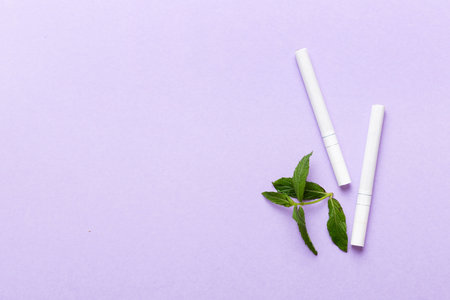 Menthol cigarettes and fresh mint leaves on colored background, Many cigarettes stacked together top view flat lay.の写真素材