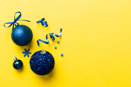 Christmas ball on colored background. decoration bauble with ribbon bow with copy space.の写真素材