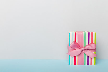 holiday paper present tied pink ribbon bow top view with copy space. Flat lay holiday background. birthday or christmas present. Christmas gift box concept with copy space.の写真素材