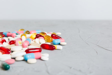 Many different colorful medications and pills perspective view. Set of many pills on colored...