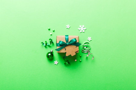 Top view Flat lay Christmas decorations and gift box on colored background with copy space. Christmas or Happy New Year composition.の写真素材