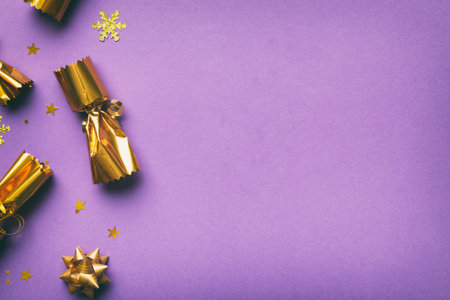 Christmas crackers with shiny confetti on color background, top view, copy space.の写真素材