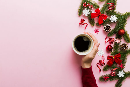 Woman holding cup of coffee. Woman hands holding a mug with hot coffee. Winter and Christmas time...