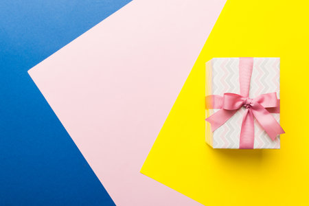 holiday paper present tied pink ribbon bow top view with copy space. Flat lay holiday background. birthday or christmas present. Christmas gift box concept with copy space.の写真素材