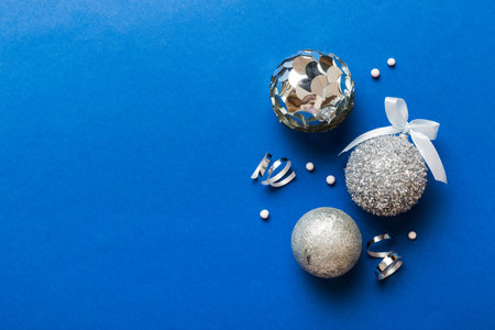 Christmas ball on colored background. decoration bauble with ribbon bow with copy space.の写真素材