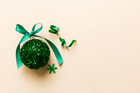 Christmas ball on colored background. decoration bauble with ribbon bow with copy space.