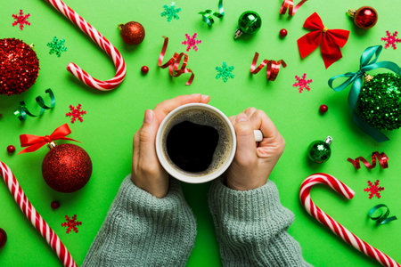 Woman holding cup of coffee. Woman hands holding a mug with hot coffee. Winter and Christmas time concept.の写真素材