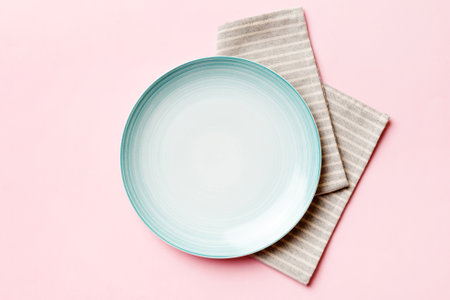 Top view on colored background empty round Blue plate on tablecloth for food. Empty dish on napkin with space for your design.の写真素材