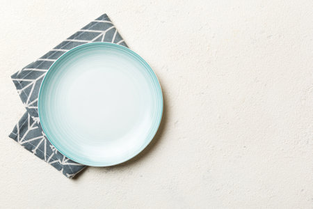 Top view on colored background empty round Blue plate on tablecloth for food. Empty dish on napkin with space for your design.の写真素材