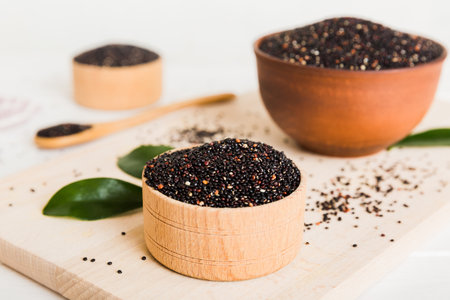 quinoa seeds in bowl and spoon on colored background. Healthy kinwa in small bowl. Healthy superfood.の写真素材