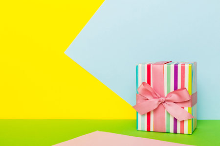 holiday paper present tied pink ribbon bow top view with copy space. Flat lay holiday background. birthday or christmas present. Christmas gift box concept with copy space.の写真素材