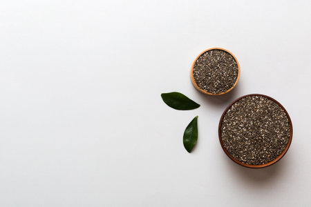 Chia seeds in bowl on colored background. Healthy Salvia hispanica in small bowl. Healthy superfood.の写真素材