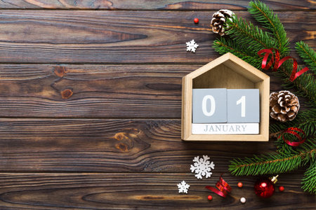 Christmas calendar 1 january. Christmas gift, fir branches, pine cones. Flat lay, top view. New Year decorations on a colored background.の写真素材