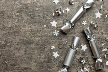 Christmas crackers with shiny confetti on color background, top view, copy space.の写真素材