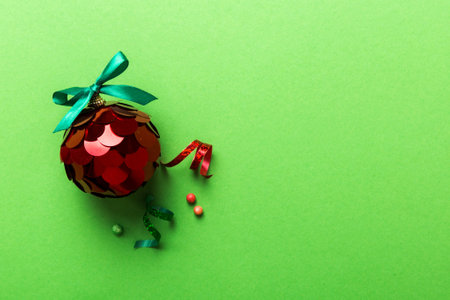 Christmas ball on colored background. decoration bauble with ribbon bow with copy space.の写真素材
