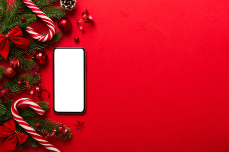 Digital phone mock up with rustic Christmas decorations for app presentation top view with empty space for you design. Christmas shopping concept. Tablet with copy space on colored background.の写真素材