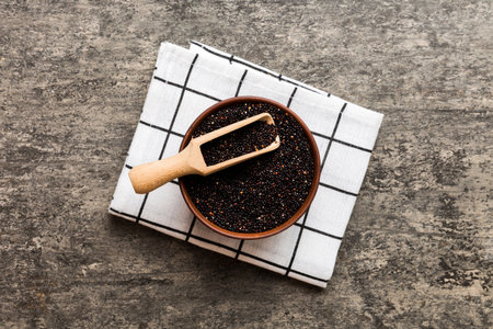 quinoa seeds in bowl and spoon on colored background. Healthy kinwa in small bowl. Healthy superfood.の写真素材