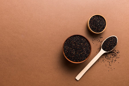 quinoa seeds in bowl and spoon on colored background. Healthy kinwa in small bowl. Healthy superfood.の写真素材